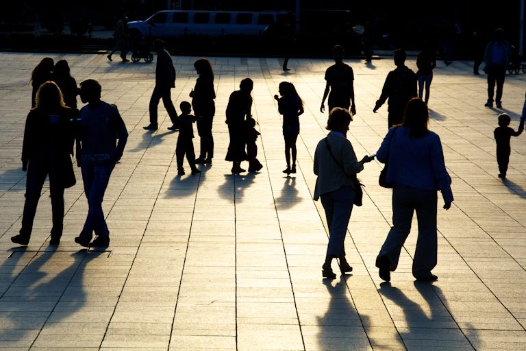A group of people on the street including children and adults