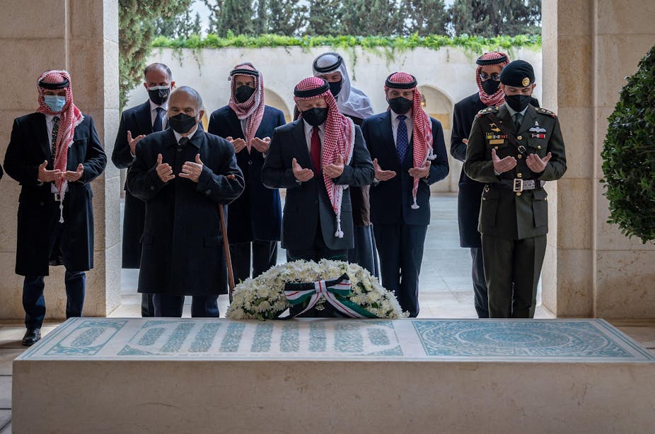 King Abdullah II of Jordan and various princes stand in prayer in front of the tomb of the late King Hussain at the royal cemetery in Amman, Jordan in April 2021.