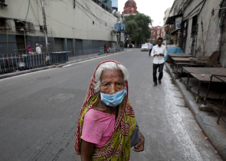 Woman with face mask on streets of Kolkata
