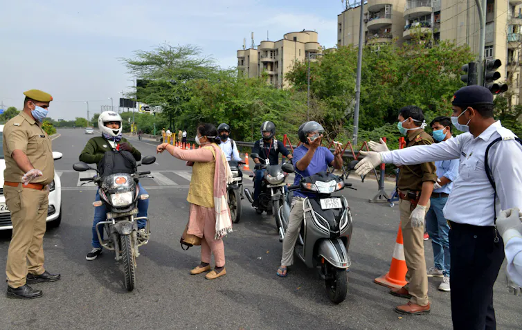 Police in India stopping commuters to ask why they are out during lockdown, New Delhi, India, March 24 2020.