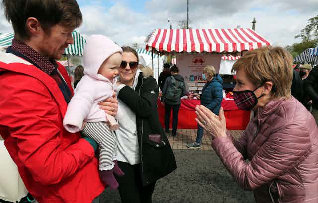 Nicola Sturgeon meeting a baby on the campaign trail. 