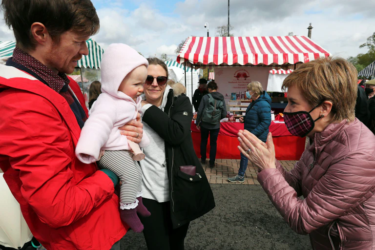 Nicola Sturgeon meeting a baby on the campaign trail.