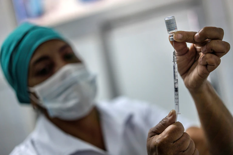 A nurse prepares an injection needle with Cuba's Soberana 2 vaccine.