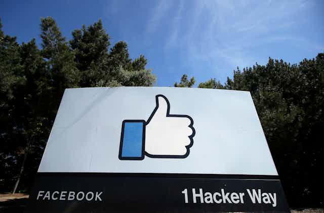 A street sign shows Facebook's thumbs up 'Like' logo at its headquarters in Menlo Park, California