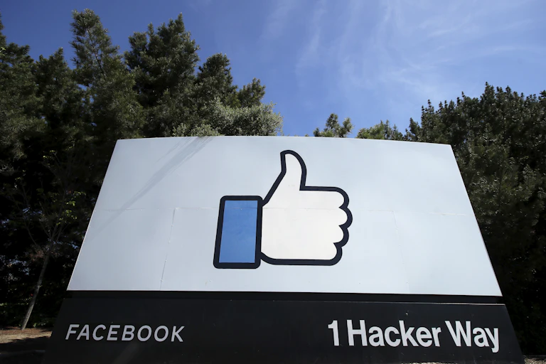 A street sign shows Facebook's thumbs up 'Like' logo at its headquarters in Menlo Park, California