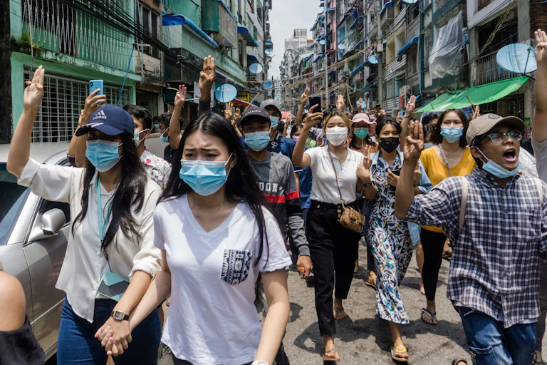 Burmese women wearing face masks march on the streets, wearing face masks