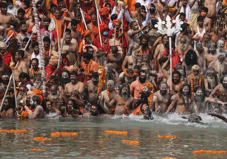 Hindu men take dips in the Ganges River