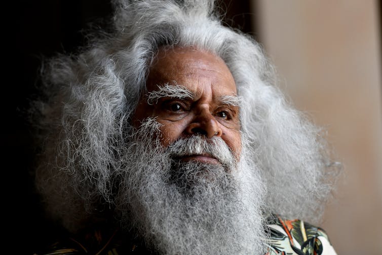 Indigenous man with bushy beard.