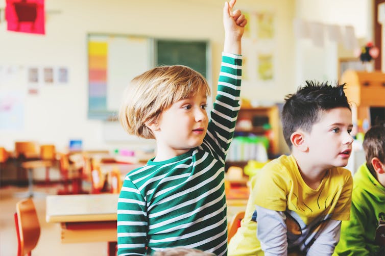 Two boys in a classroom.