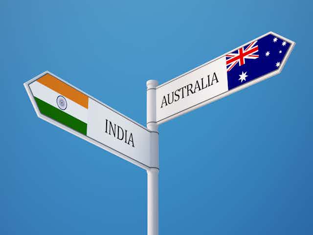 A sign, in one direction pointing to India, and in the other, Australia