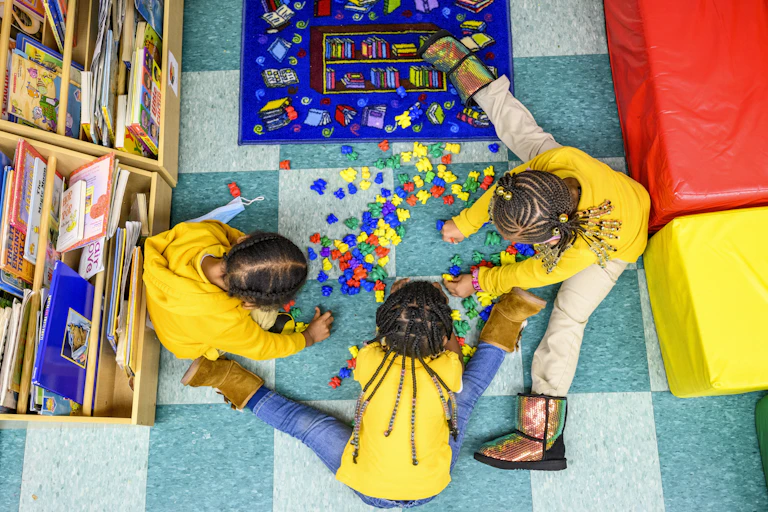 Three children play together at daycare center