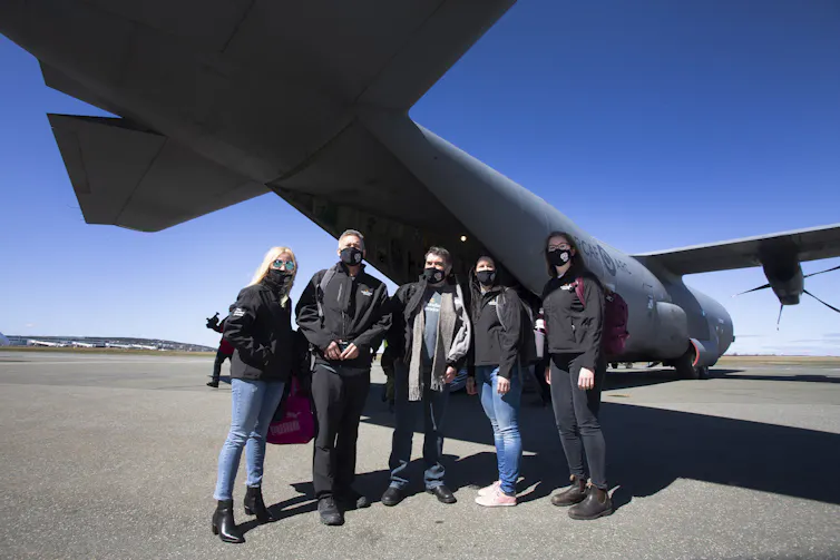 A group of health-care workers about to board a plane