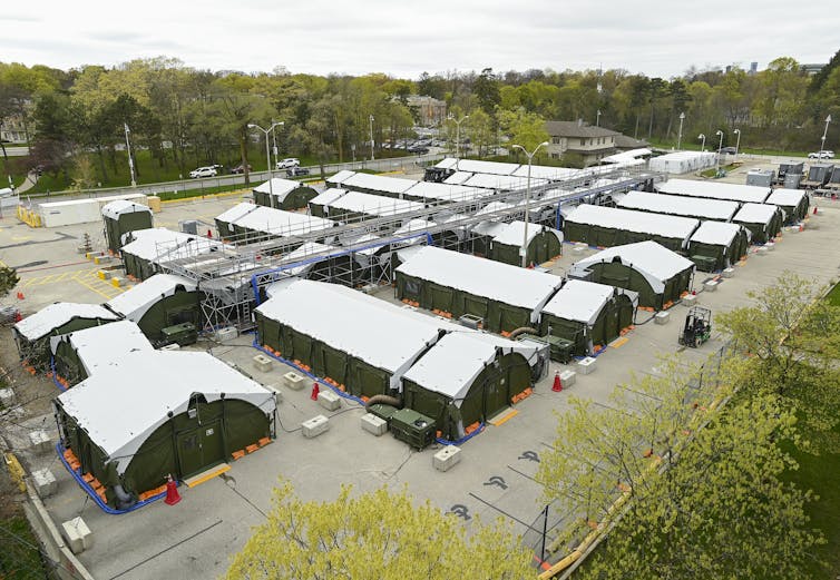 Exterior shot of temporary buildings in a parking lot.