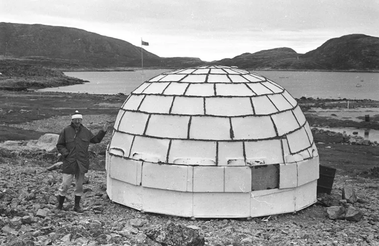 person standing beside styrofoam igloo