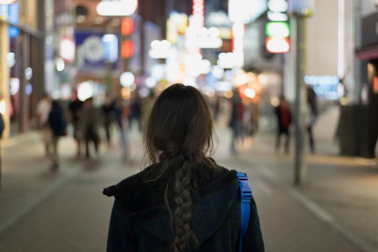 Woman alone in crowd