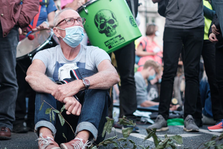 A protestor sits on the ground.