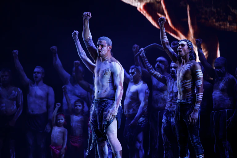 Aboriginal men hold up fists.