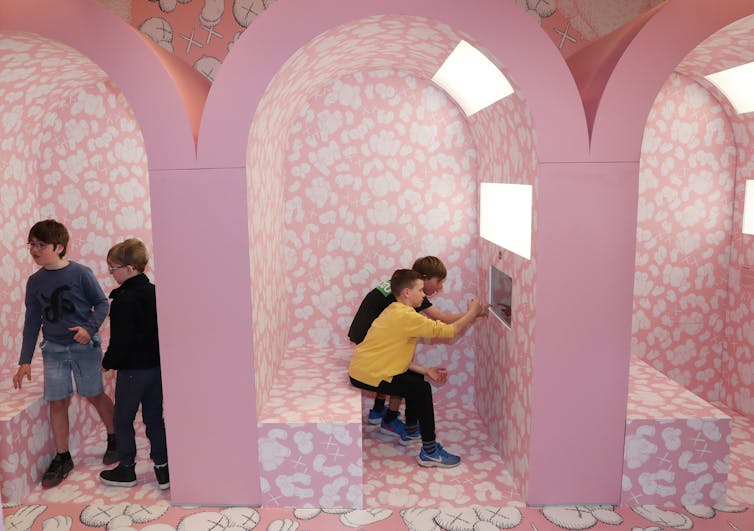 Children in a pink art gallery