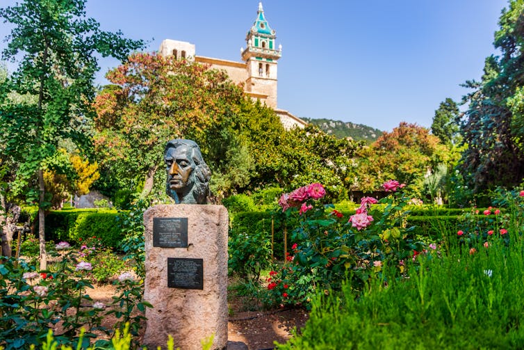 bust in lush garden