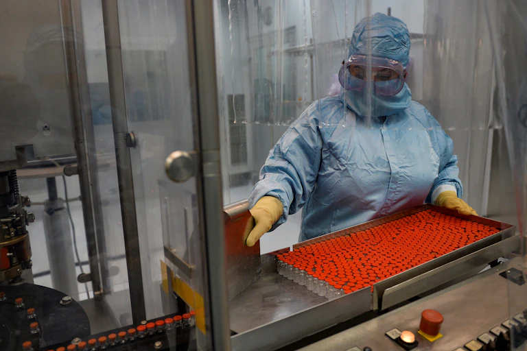 A technician with a batch of vaccine vials in Cuba.