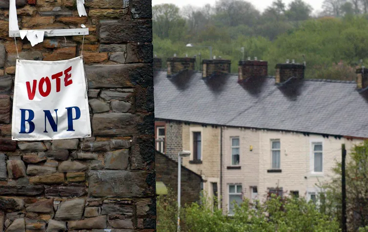 Banner on wall with houses in background.
