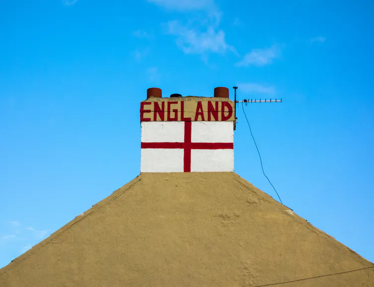 St George cross flag painted on chimney. of house.