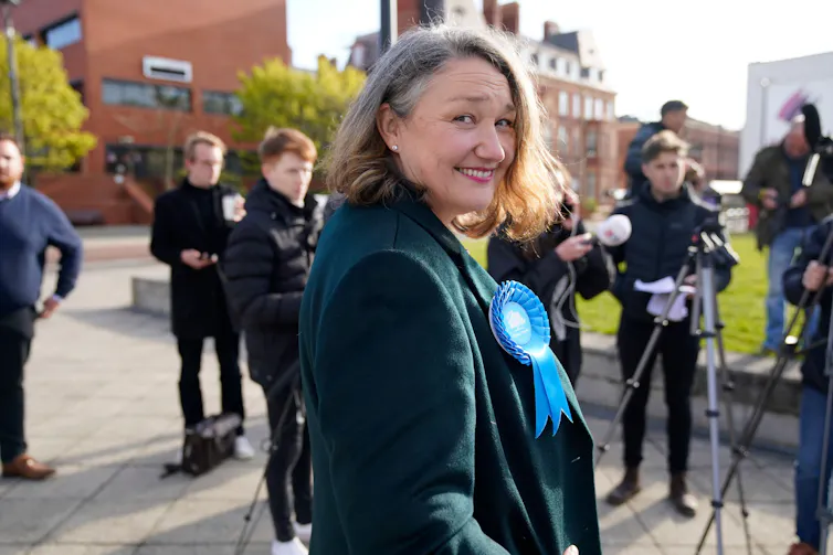 Conservative MP Jill Mortimer in front of a line of press photographers.