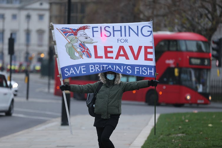 Protester holding sign 'Fishing for Leave'