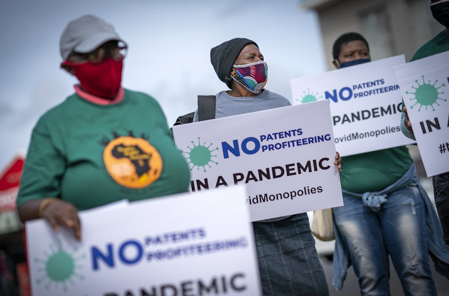 Members of the People's Vaccine Campaign of South Africa protest outside the Johnson & Johnson offices in Cape Town, South Africa.