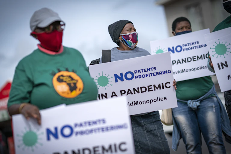 Members of the People's Vaccine Campaign of South Africa protest outside the Johnson & Johnson offices in Cape Town, South Africa.