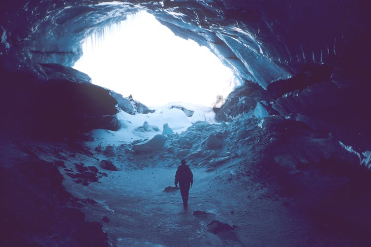 The author inside a giant icy chasm within a glacier.