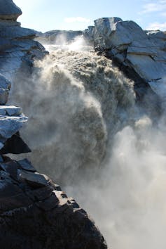 A waterfall at the edge of a glacier.