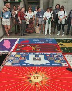 People looking at the AIDS Memorial Quilt