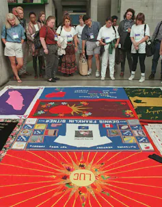 People looking at the AIDS Memorial Quilt