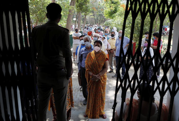 Indians in Prayagraj line up for a COVID vaccine.