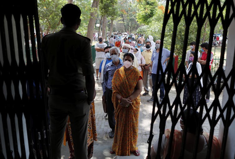 Indians in Prayagraj line up for a COVID vaccine.