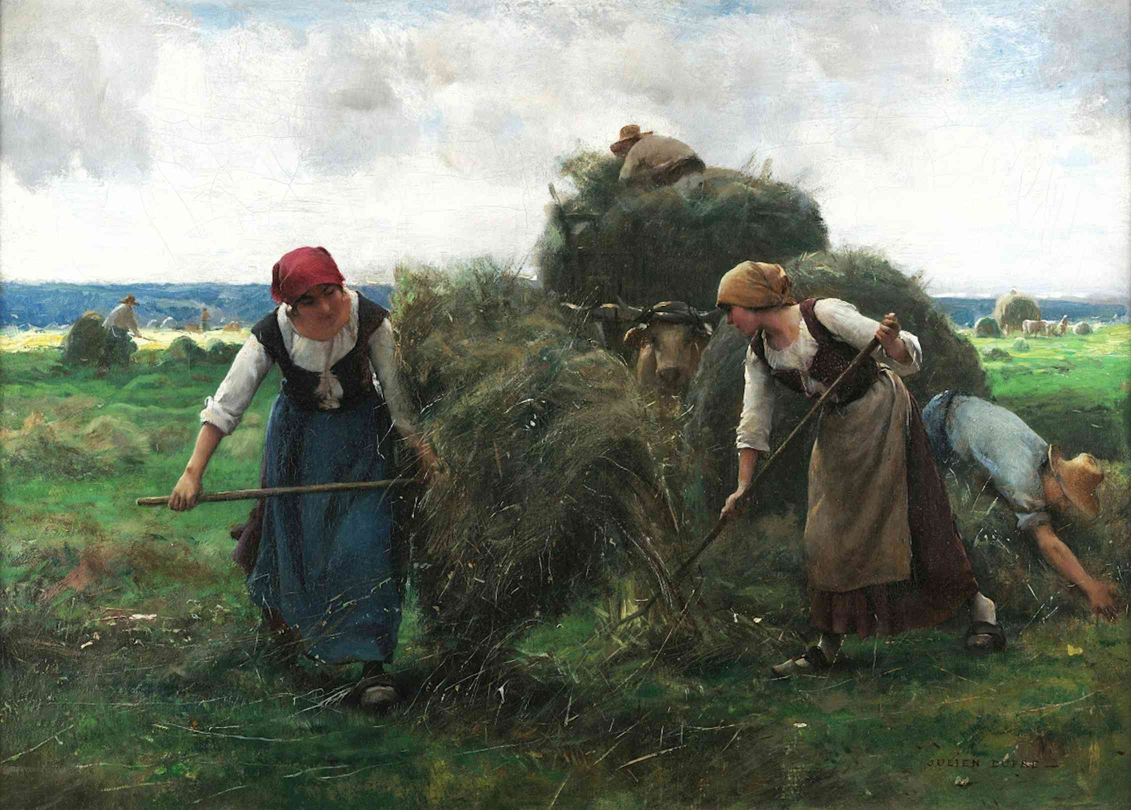 Two women baling hay.