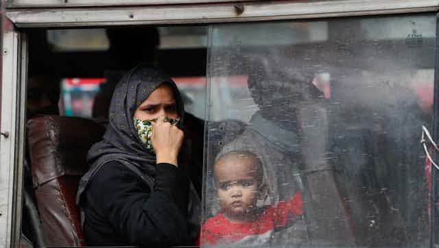 An Indian mother and her infant on a bus in New Delhi.