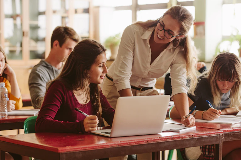 Teacher helping students in class.