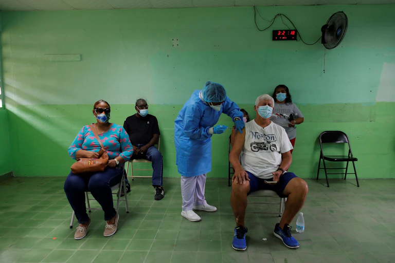 A man receives the second dose of the Pfizer vaccine against covid-19, at the Republica de Colombia school, in San Miguelito, Panama