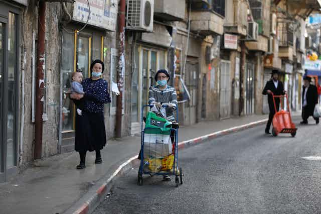 Ultra-Orthodox women walk down street in Jerusalem 
