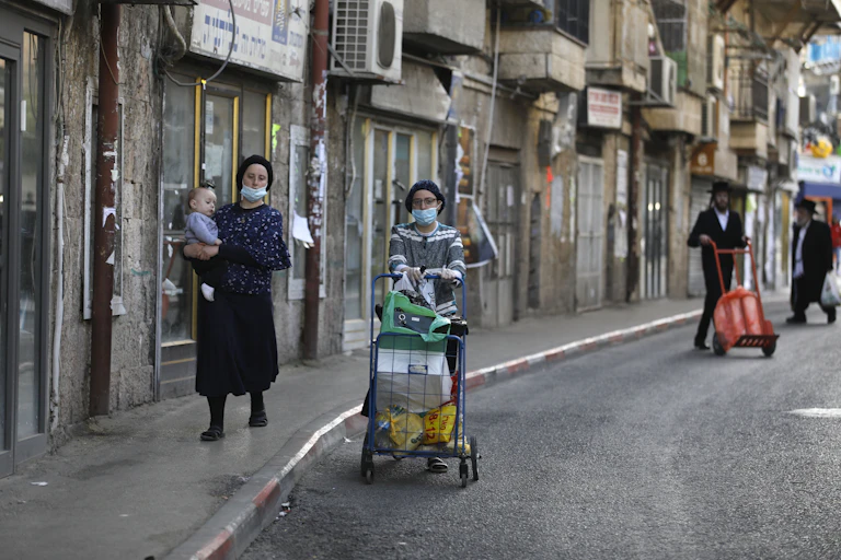 Ultra-Orthodox women walk down street in Jerusalem