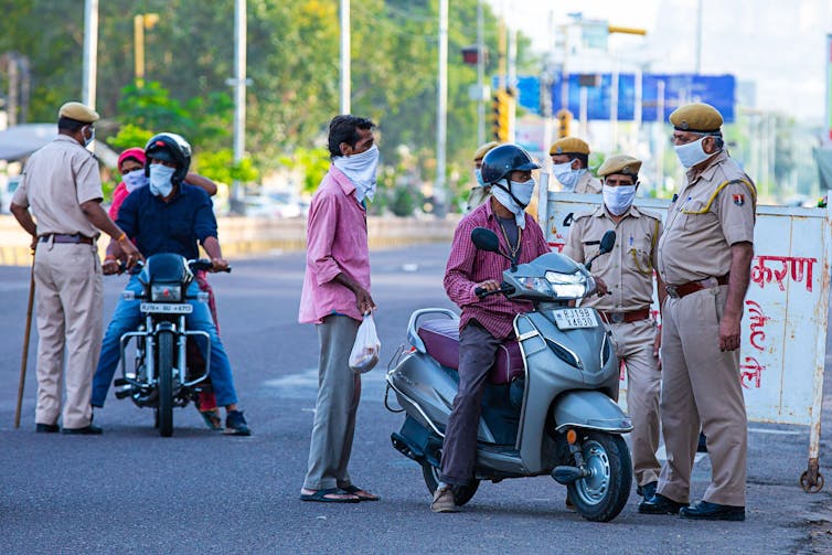 Indian police stopping citizens during lockdown.