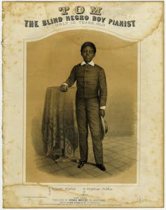 title reads TOM The Blind Negro Boy Pianist Only 10 Years Old and has an illustration of a boy in dark jacket with white collar and cuffs, standing with his arm on a table. He holds his hat in the other hand.