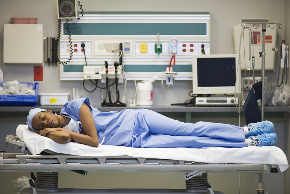 sleeping healthcare worker laying on hospital gurney