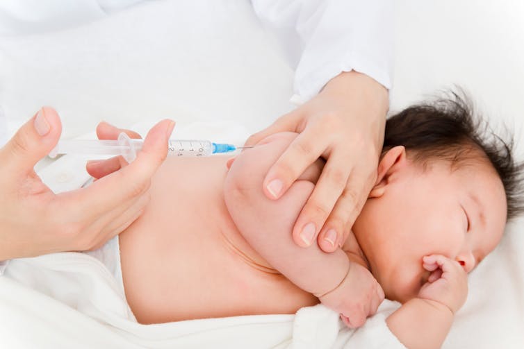 An infant being vaccinated