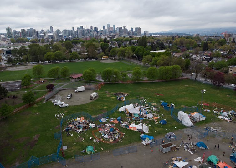 Drone shot of tent camp in park in Vancouver's Strathcona Park. Tents amid baseball field