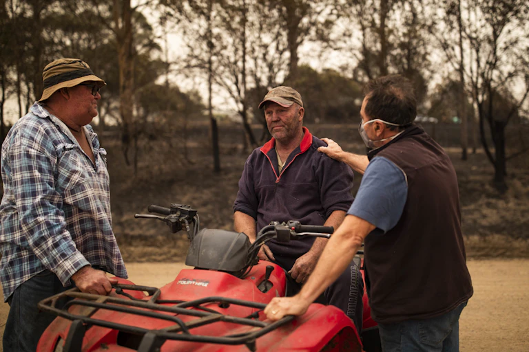 Bushfire survivors console each other.