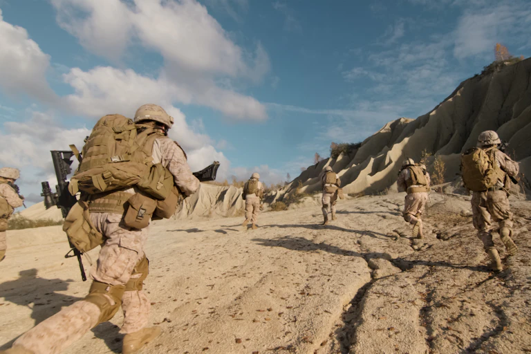 Military personnel in desert.
