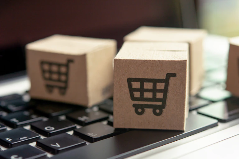 Cardboard cubes with trolley picture sat on a laptop keyboard